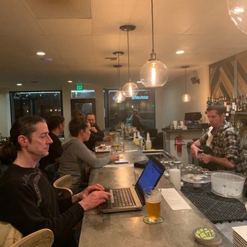 Box Bar - a group of people sitting at a bar - Cocktail Bars Near Me - Seattle, Washington Box Bar - a group of people sitting at a bar - Cocktail Bars Near Me - Seattle, Washington