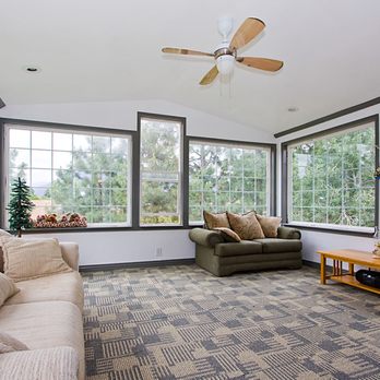 PDX Builders& Design - a sunroom with a couch, loveseat, and fan - General Contractors Near Me PDX Builders& Design - a sunroom with a couch, loveseat, and fan - General Contractors Near Me