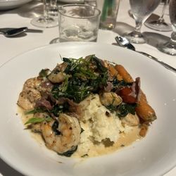 Langdon's - The Shrimp- grilled shrimp with tails husked (as it should be) with prosciutto, roaster tomatoes, scallions, and smoked bacon atop grits.