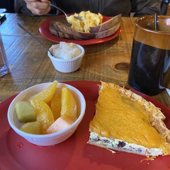 Bella's Breakfast & Lunch - Quiche with a side of fruit three egg plate with sausage patty, grits and toast. - Breakfast & Brunch Near Me - Banner Elk, North Carolina