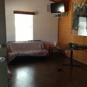 Frio Acres - Living room. Covered the futon with a sheet to keep it clean. Looked like they for new mattresses this year-nice! - Vacation Rentals Near Me - Concan, Texas