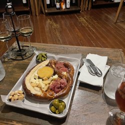 Carrera Wine Cellar - Beer cheese pretzel charcuterie board, ancient city orange beer and a white classic wine flight and water: