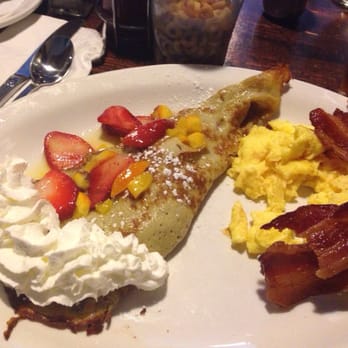 Rusty Pelican Cafe - Strawberry crepes w/tropical sauce, scrambled eggs, and thick smokey bacon. Delicious! - Desserts Near Me - Mill Creek, Washington Rusty Pelican Cafe - Strawberry crepes w/tropical sauce, scrambled eggs, and thick smokey bacon. Delicious! - Desserts Near Me - Mill Creek, Washington