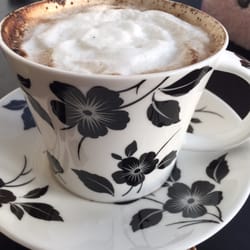 Cute cup with home brewed cappuccino.