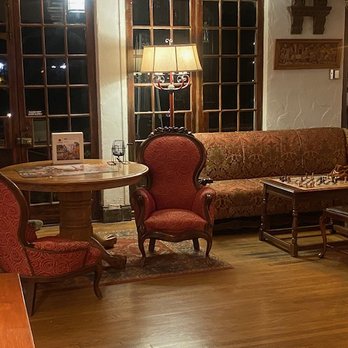Benbow Historic Inn - Large common area room with chess board, puzzle tables, reading area, fireplace, and a baby grand piano - Hotels Near Me - Garberville, California