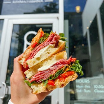 Casetta Kitchen and Counter - a person holding a sandwich - Italian Near Me - Madison, Wisconsin Casetta Kitchen and Counter - a person holding a sandwich - Italian Near Me - Madison, Wisconsin