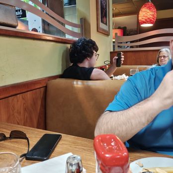 Denny's - The employee vaping directly behind us.  He was on break - Diners Near Me - Tomball, Texas