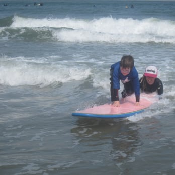 Surf Camp Pacifica - Catching a wave with the help of an instructor. - Surf Schools Near Me - Pacifica, California