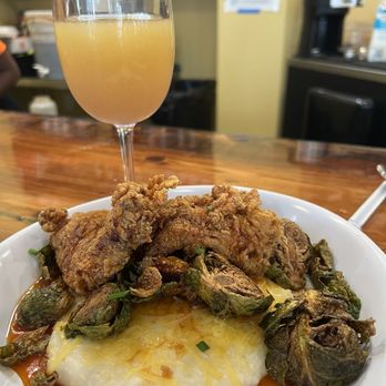 Ruby Slipper Central Business District - Sweet Heat Crispy Brussel Sprouts with bacon onion jam over cheese grits - Breakfast & Brunch Near Me - New Orleans, Louisiana Ruby Slipper Central Business District - Sweet Heat Crispy Brussel Sprouts with bacon onion jam over cheese grits - Breakfast & Brunch Near Me - New Orleans, Louisiana