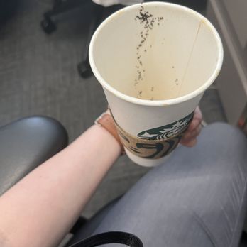Starbucks - a person holding a cup of coffee - Coffee & Tea Near Me - Islip, New York