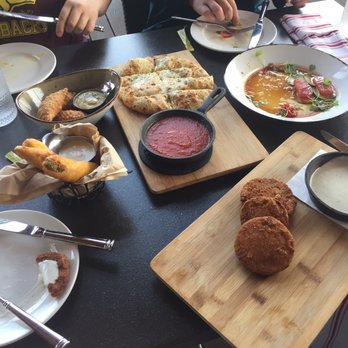 Region's 117 - Selection of apps. Notice the cheese bread with tomato jam--hey wait, that's not tomato jam--that's a bowl of marinara! - New American Near Me - Lake Frederick, Virginia