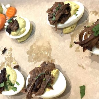 Dudley's Sports Grill - Brisket Deviled Eggs Sriracha dressing on the side - Sports Bars Near Me - Rockwall, Texas Dudley's Sports Grill - Brisket Deviled Eggs Sriracha dressing on the side - Sports Bars Near Me - Rockwall, Texas