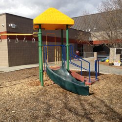 Sanborn Elementary - The preschool playground includes a small climbing structure, tricycles, basketball hoops, and a variety of toys to enhance outdoor learning