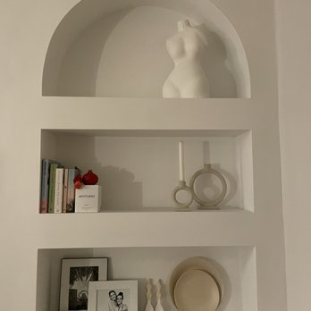 Handymin Help - a shelf with a statue and other items - Handyman Near Me