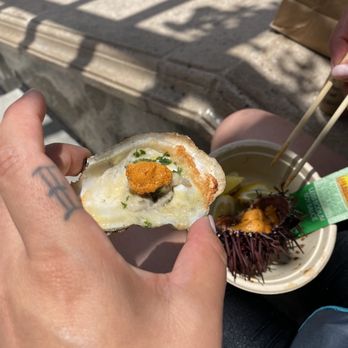 Captain Jack's - Butter garlic oyster (cooked), with cheese and parsley with uni on top. I do add a touch of soy sauce and lemon juice. - Caterers Near Me