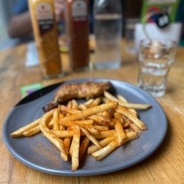 a plate of french fries and a hot dog a plate of french fries and a hot dog