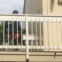 Koolau Vista Homeowners Assn - Maintenance guy using gas powered blower in inside courtyard outside apartment front doors.... still