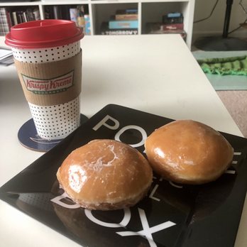 Krispy Kreme - two doughnuts on a plate next to a cup of coffee - Donuts Near Me - Columbus, Ohio