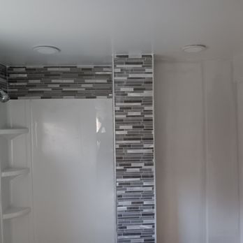 Newlife Remodeling - a bathroom with a shower - Electricians Near Me Newlife Remodeling - a bathroom with a shower - Electricians Near Me