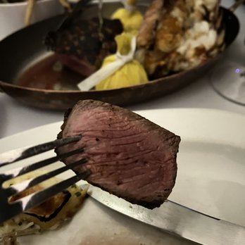 Harbour 60 - a steak on a fork on a plate - Steakhouses Near Me - Toronto, Ontario