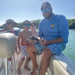 My 9 year old with his first fish (and Captain Chase, who he admired very much) My 9 year old with his first fish (and Captain Chase, who he admired very much)