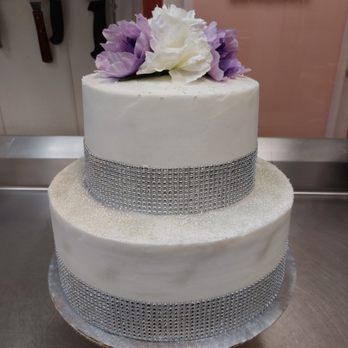 Tu Bakery - a three tiered cake with purple and white flowers - Bakeries Near Me - Raeford, North Carolina Tu Bakery - a three tiered cake with purple and white flowers - Bakeries Near Me - Raeford, North Carolina