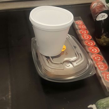 Winn Dixie - a plastic cup on a tray on a conveyor belt - Grocery Near Me - Hallandale Beach, Florida