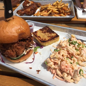 Basilisk - Chicken sandwich, Mac salad & corn bread. Chicken legs and fries in background. - New American Near Me - Portland, Oregon