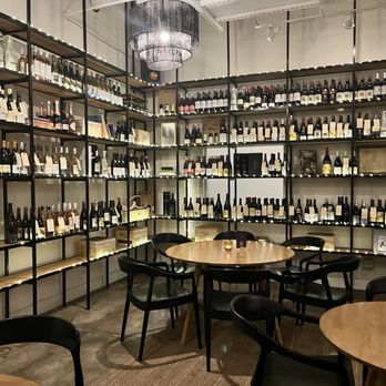Cape Bottle Room - wine bottles on shelves and tables - Wine Bars Near Me - Austin, Texas