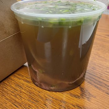 Mo Pho Mi - Takeout container - Regular-size rare beef pho with just the meat added to the broth. No noodles added and it already reached the top - Vietnamese Near Me - Costa Mesa, California Mo Pho Mi - Takeout container - Regular-size rare beef pho with just the meat added to the broth. No noodles added and it already reached the top - Vietnamese Near Me - Costa Mesa, California
