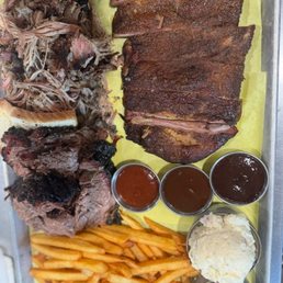 Pulled pork, brisket, ribs, fries, potato salad, house made bbq sauces, and house made pickles Pulled pork, brisket, ribs, fries, potato salad, house made bbq sauces, and house made pickles