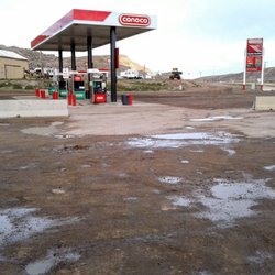 Conoco - Rain turns dirt parking lot into mud.