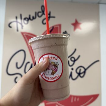 Backyard Concessions - a hand holding a cup of milkshake - Shaved Ice Near Me - San Antonio, Texas Backyard Concessions - a hand holding a cup of milkshake - Shaved Ice Near Me - San Antonio, Texas