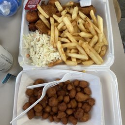Seafood dinner with fries and coleslaw with a side of fried cauliflower Seafood dinner with fries and coleslaw with a side of fried cauliflower