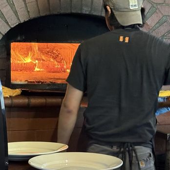 Brick & Fire Bistro - Pizza guy managing the brick oven - Mediterranean Near Me - Eureka, California Brick & Fire Bistro - Pizza guy managing the brick oven - Mediterranean Near Me - Eureka, California