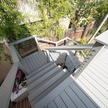 ProDeck Construction - Looking down the stair case from upper deck to lower. - Decks & Railing Near Me