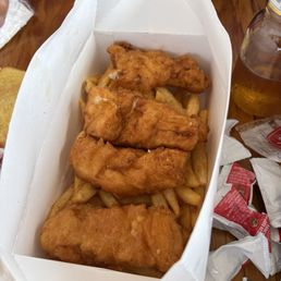 Halibut fish and chips. Served with tartar sauce below. Good to share! Halibut fish and chips. Served with tartar sauce below. Good to share!