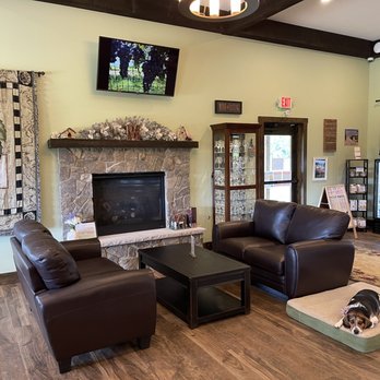 Magnolia Vineyards - a living room with a fireplace, couches, and a dog bed - Wineries Near Me - Amissville, Virginia Magnolia Vineyards - a living room with a fireplace, couches, and a dog bed - Wineries Near Me - Amissville, Virginia