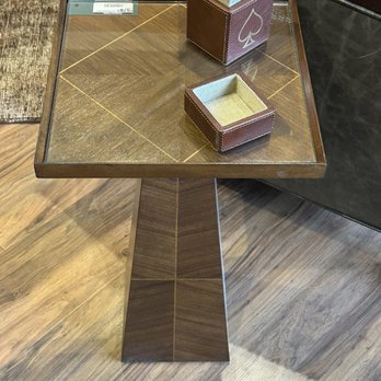 Designer's Studio - Cool end table in their show room - A square wooden side table with a tapered base, featuring a card holder and a small box on top, situated in a furniture store. - Interior Design Near Me - Centre Hall, Pennsylvania