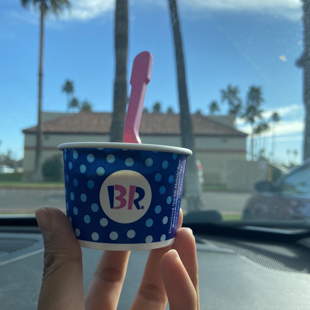 a hand holding a cup of ice cream a hand holding a cup of ice cream