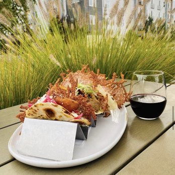 Madre - Boutique Taqueria - a plate of food and a glass of wine - Tacos Near Me - Boise, Idaho
