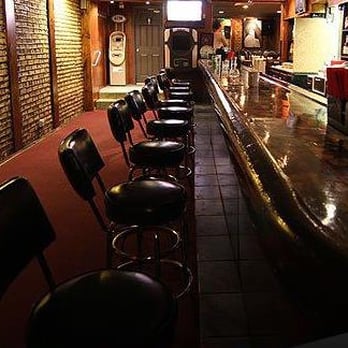Sunnyday Tap - a long bar lined with stools - New American Near Me - Chicago, Illinois