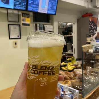 Blenz Coffee - a person holding a glass of beer - Coffee & Tea Near Me - Vancouver, British Columbia