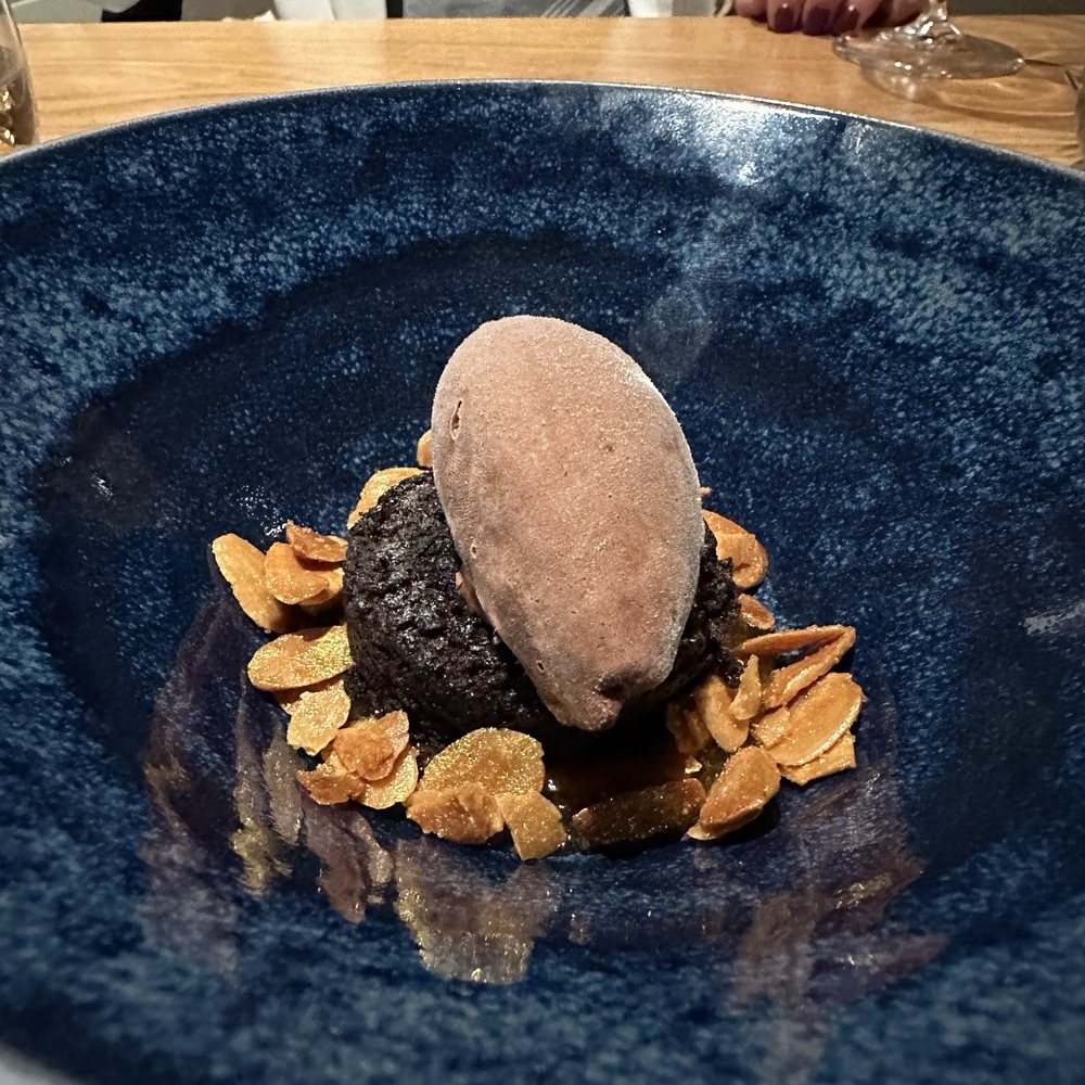 Gluten free, dairy free chocolate cake and ice cream with orange candied almonds
