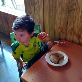 Russell's Bakery - Kiddo at the little table, enjoying the oatmeal raisin. - Bakeries Near Me - Austin, Texas Russell's Bakery - Kiddo at the little table, enjoying the oatmeal raisin. - Bakeries Near Me - Austin, Texas