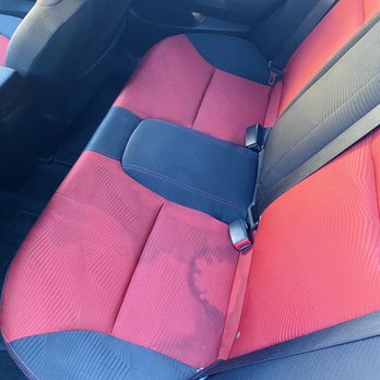 Auto Detailing Center - Before photo ~ back seats filled with dark stains - Auto Detailing Near Me