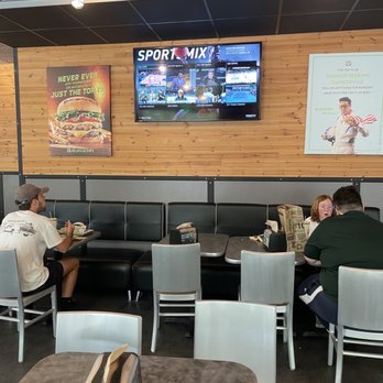 BurgerFi - people sitting at tables in a sports restaurant - Burgers Near Me - Tampa, Florida