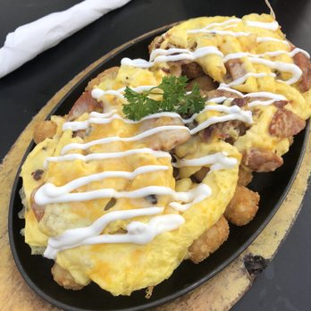 Stacks Pancake House - Brekkie tater tots - smothered with egg, portuguese sausage, bacon, cheese, and sour cream. YUM! - Breakfast & Brunch Near Me - Irvine, California