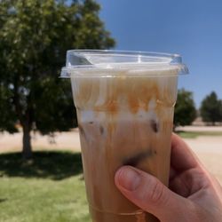 The Alibi Coffee House - Small iced caramel macchiato, half sweet, with vanilla cold foam.