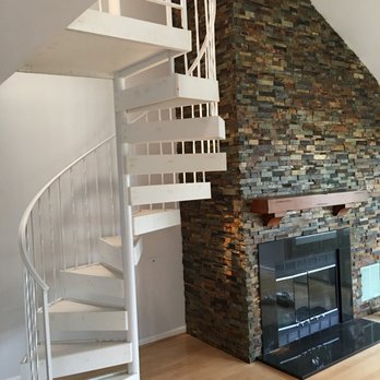 Soren Construction - a spiral staircase in a living room - Plumbing Near Me - Rockville, Maryland